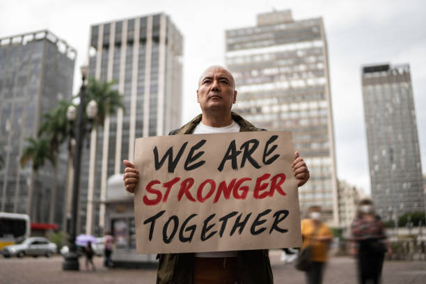 Man holding signs during on a demonstration outdoors