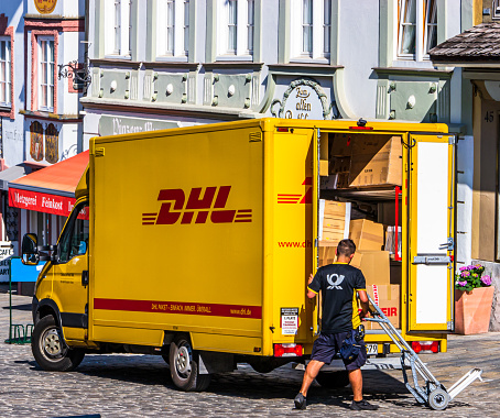 Bad Tolz, Germany - July 17: typical german dhl truck at the old town of Bad Tolz on July 17, 2013