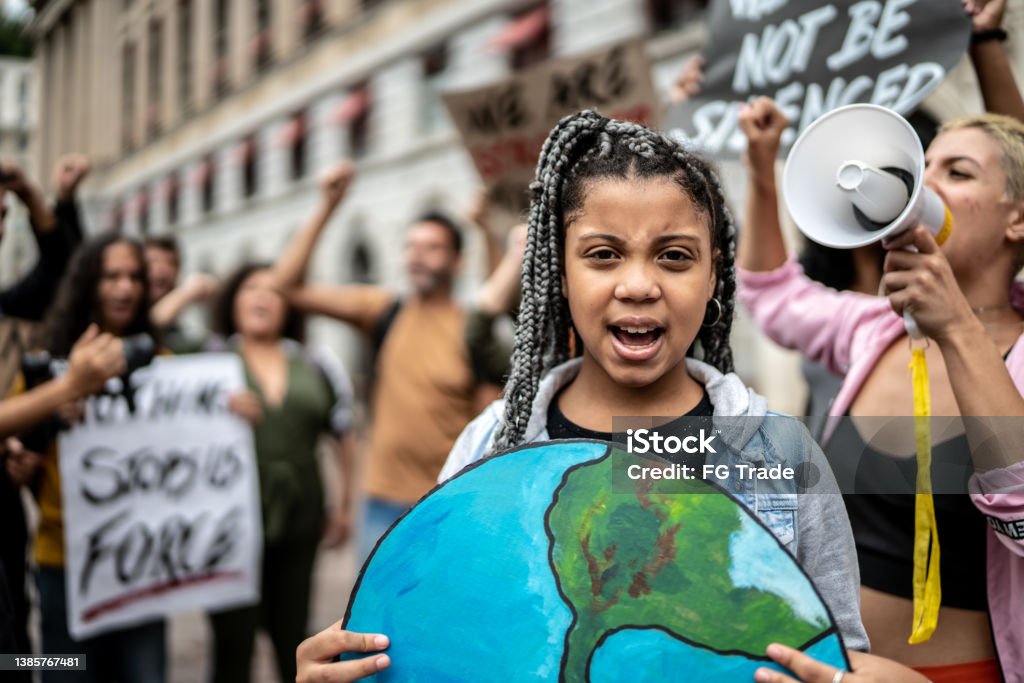 Portrait of teenage girl holding signs during on a demonstration for environmentalism Protest Stock Photo