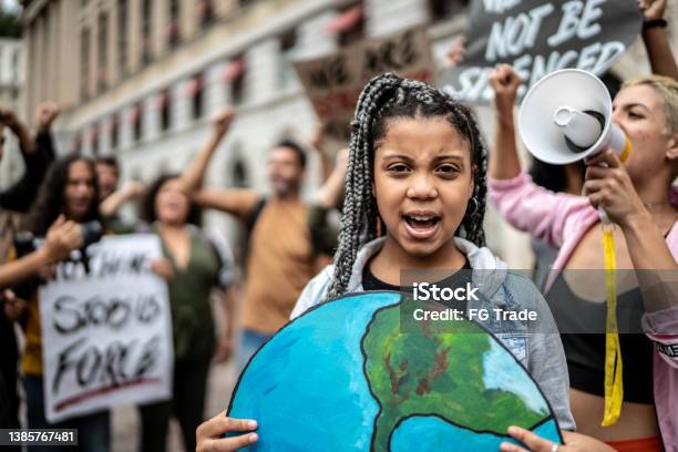 Portrait Of Teenage Girl Holding Signs During On A Demonstration For Environmentalism Stock Photo - Download Image Now