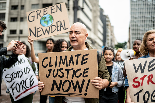 Protests holding signs during on a demonstration for environmentalism