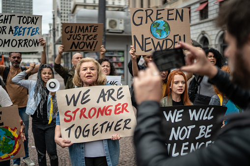 Protests holding signs during on a demonstration for environmentalism