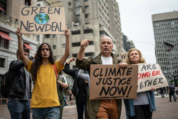 istock Protests holding signs during on a demonstration for environmentalism 1385767533