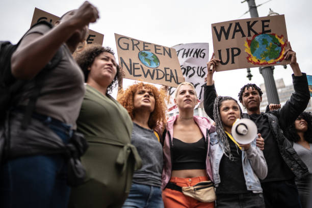 istock Protests holding signs during on a demonstration for environmentalism 1385767567