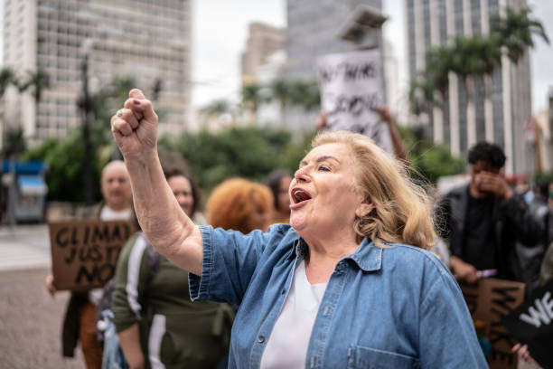 istock Senior woman leading protest 1385767578