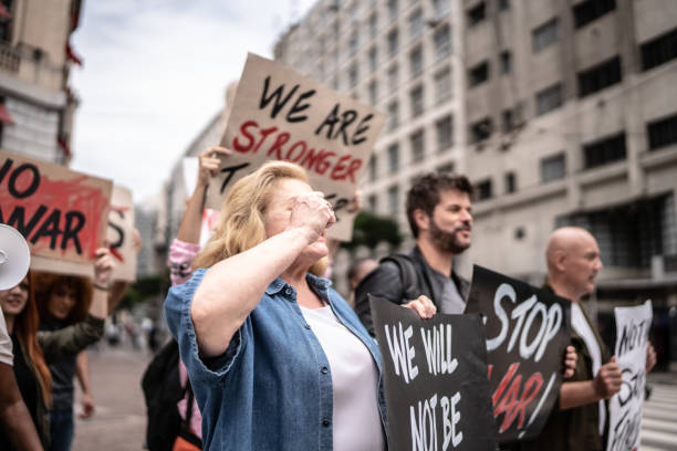 istock Protesters holding posters during a demonstration in the street 1385767977