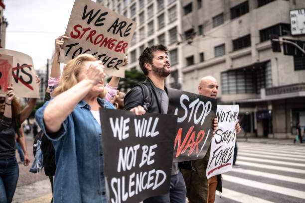 istock Protesters holding posters during a demonstration in the street 1385767987