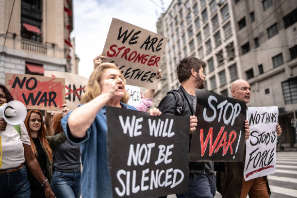 istock Protesters holding posters during a demonstration in the street 1385767999