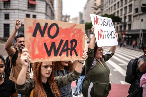 istock Protesters holding posters during a demonstration in the street 1385768001