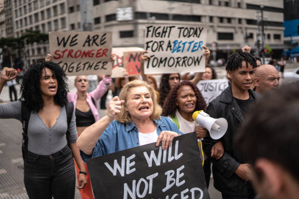 istock Protesters holding signs during a demonstration in the street 1385768002