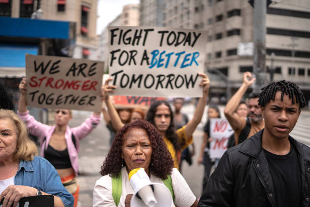 istock Senior woman leading a demonstration using a megaphone 1385768006