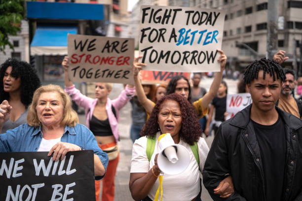 istock Senior woman leading a demonstration using a megaphone 1385768012