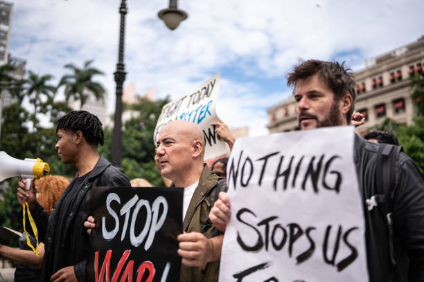 istock Protesters holding signs during a demonstration in the street 1385768019