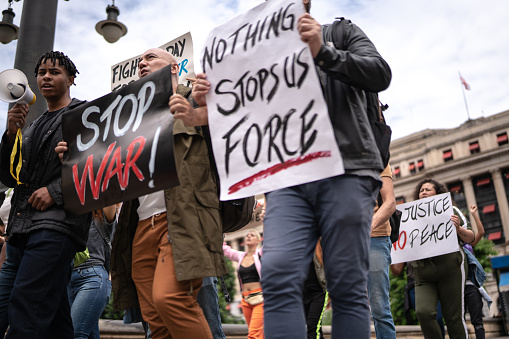 Protesters holding signs during a demonstration in the street