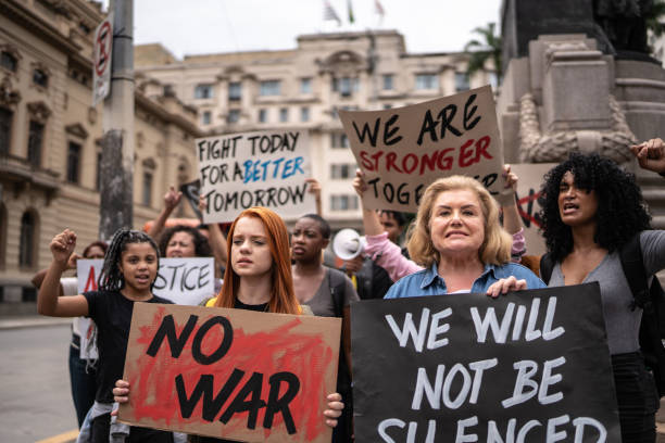 istock Protesters holding signs during a demonstration in the street 1385768033