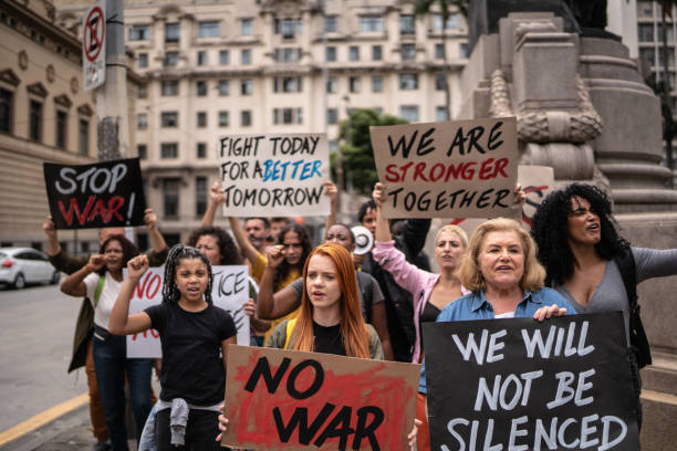 istock Protesters holding signs during a demonstration in the street 1385768035