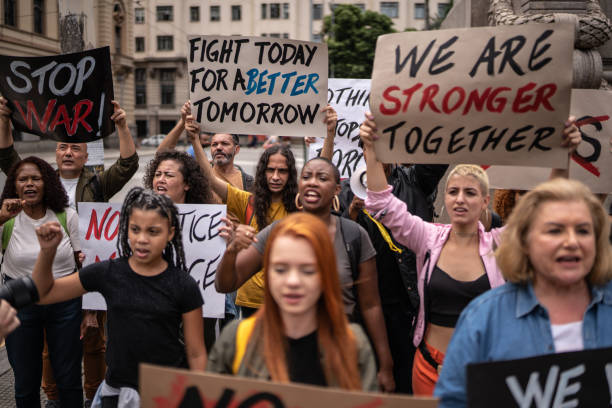 istock Protesters holding signs during a demonstration in the street 1385768541