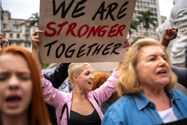 istock Protesters holding signs during a demonstration in the street 1385768557