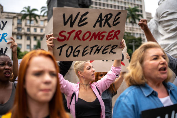istock Protesters holding signs during a demonstration in the street 1385768559