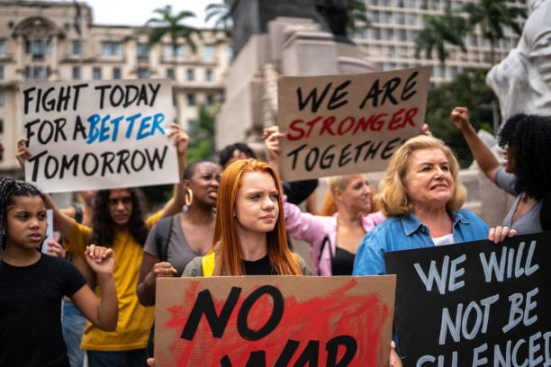 istock Protesters holding signs during a demonstration in the street 1385768565