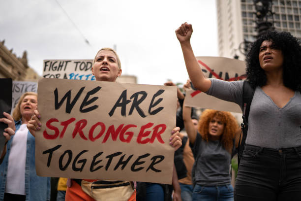 istock Protesters holding signs during a demonstration in the street 1385768577