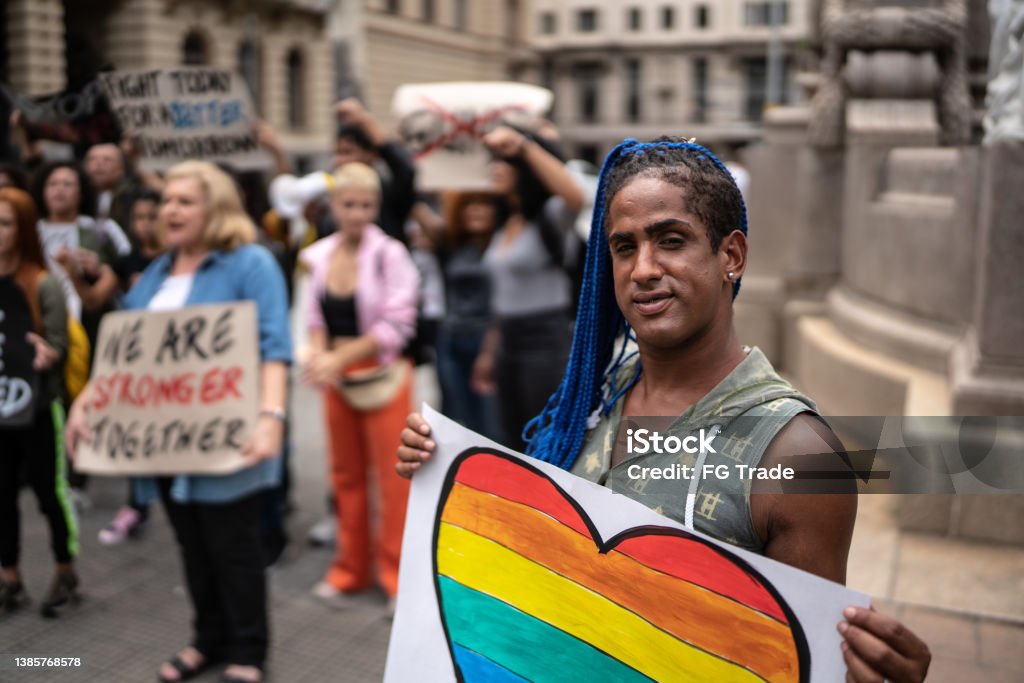 Transgender woman holding a sign during a demonstration in the street LGBTQIA Rights Stock Photo