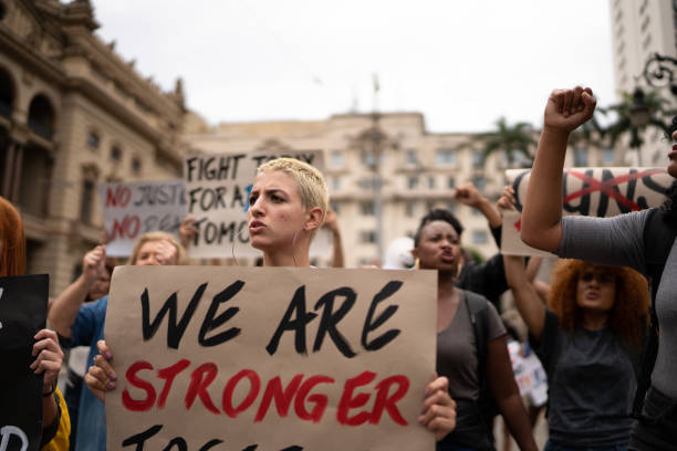istock Protesters holding signs during a demonstration in the street 1385768583