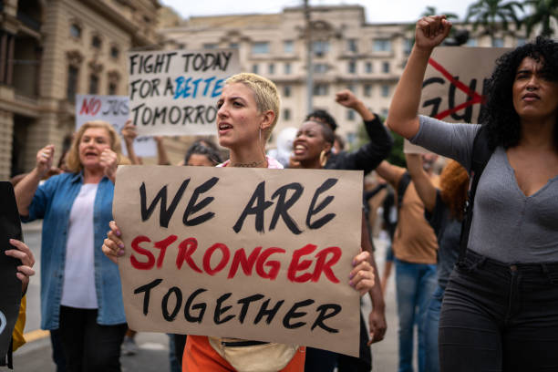 istock Protesters holding signs during a demonstration in the street 1385768584