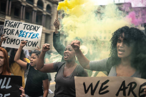 istock Protesters holding signs during a demonstration in the street 1385768590