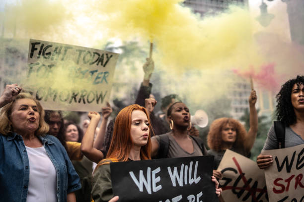 Protesters holding signs during a demonstration in the street