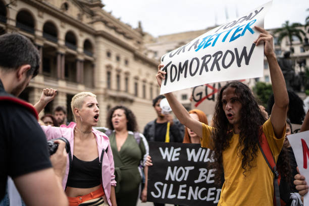 istock Protesters holding signs during a demonstration in the street 1385768622