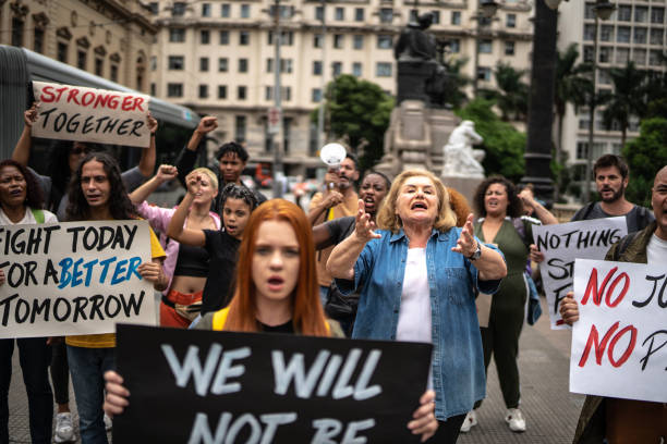 istock Protesters holding signs during a demonstration in the street 1385768629