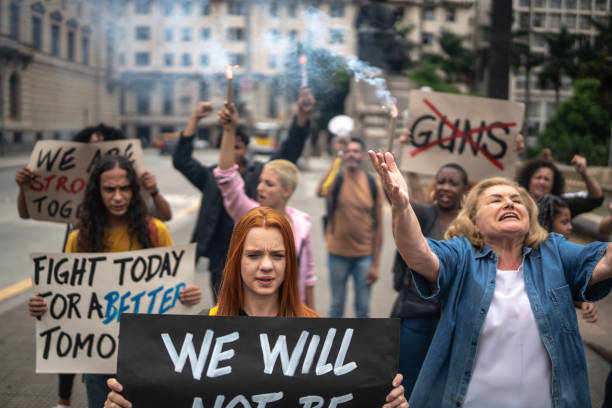 istock Protesters holding signs during a demonstration in the street 1385768638