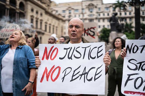 Protesters holding signs during a demonstration in the street