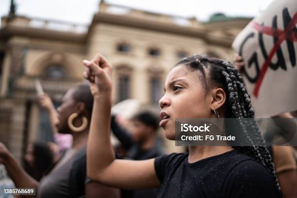 Girl During A Demonstration In The Street Stock Photo - Download Image Now - Protest, Anti-racism, Child