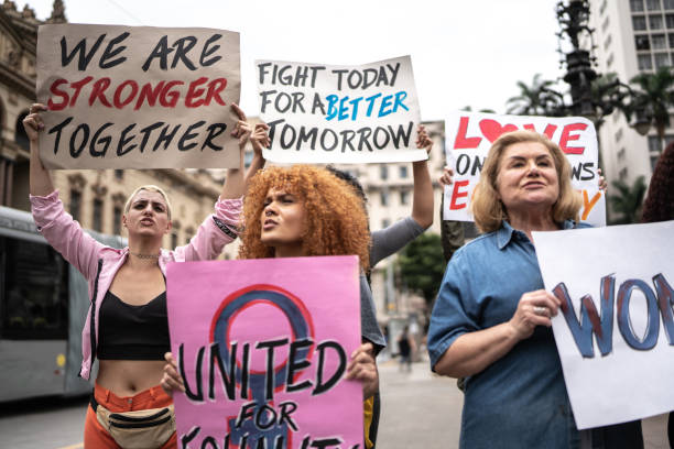istock Protesters holding signs during a demonstration in the street 1385768702