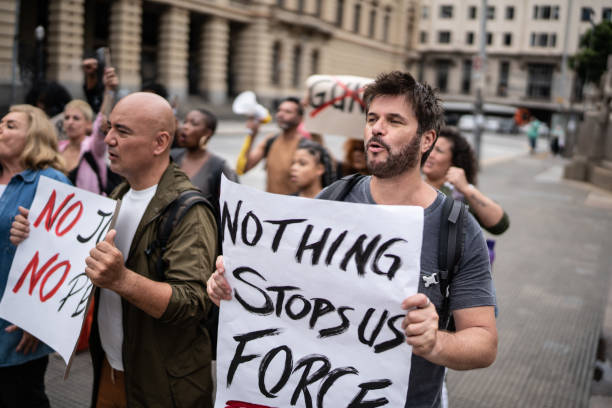istock Protesters holding signs during a demonstration in the street 1385768708