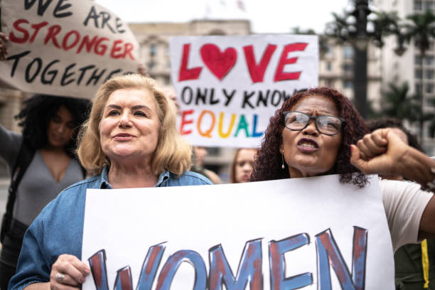 istock Protesters holding signs during a demonstration in the street 1385768713