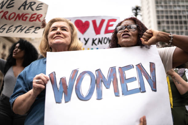 istock Protesters holding signs during a demonstration in the street 1385768721