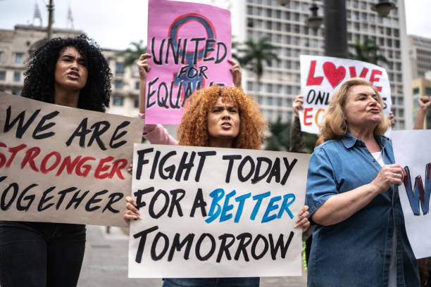 istock Protesters holding signs during a demonstration in the street 1385768726