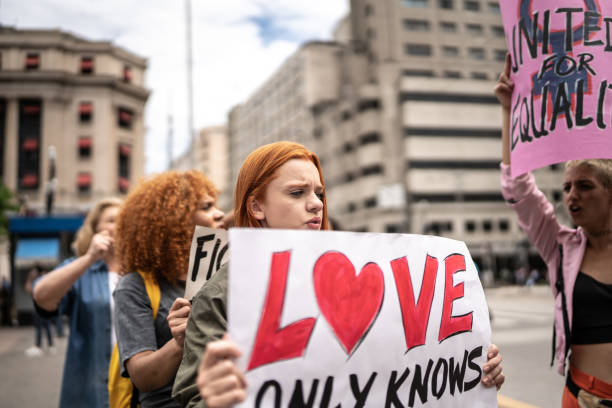 istock Protesters holding signs during a demonstration in the street 1385768742