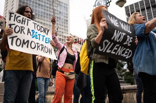 Protesters holding signs during a demonstration in the street