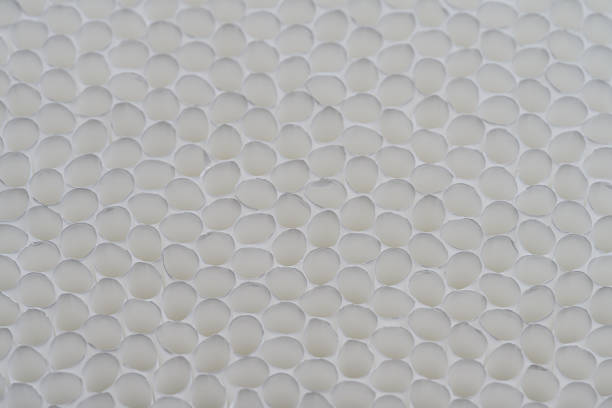 istock Empty cigarette tubes made of paper. Many white empty cigarette tubes form abstract figures with circles. 1385768991