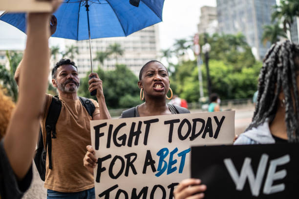 istock Protesters holding signs during a demonstration in the street 1385769199