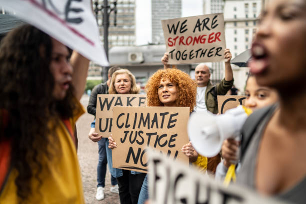 istock Protesters holding signs during a demonstration in the street 1385769205