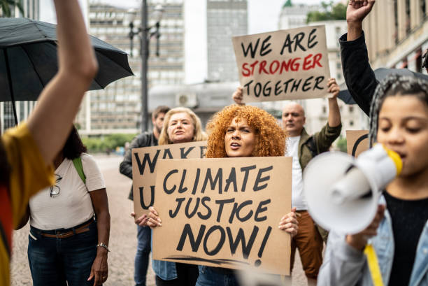 istock Protesters holding signs during a demonstration in the street 1385769210