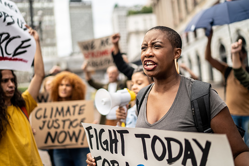 Mid adult woman shouting during a demonstration in the street