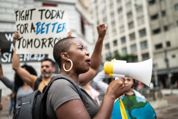 istock Mid adult woman leading a demonstration using a megaphone 1385769269