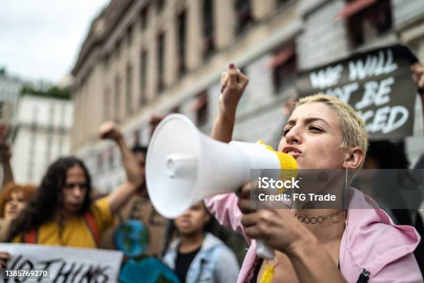 Young Woman Leading A Demonstration Using A Megaphone Stock Photo - Download Image Now