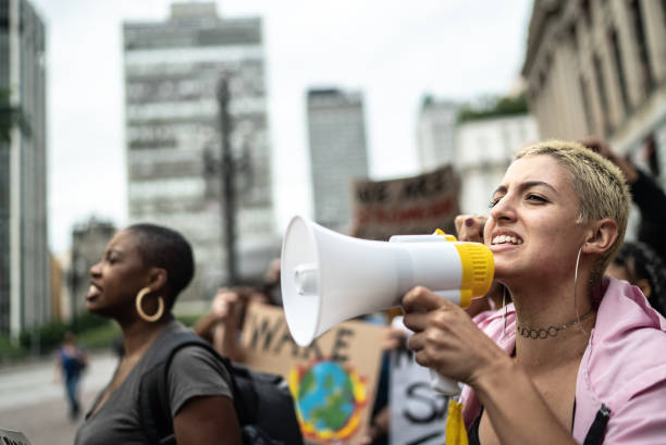 istock Young woman leading a demonstration using a megaphone 1385769272